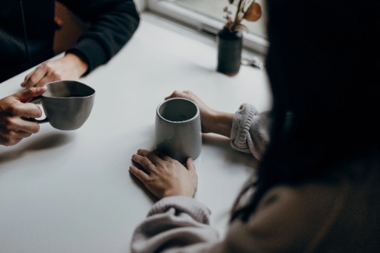 Friends sharing coffee at a table